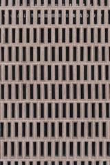 Pattern of brick blocks with 0 form. Texture of brick blocks, modern ceramic pieces. Vertical shot of a backdrop for architecture.