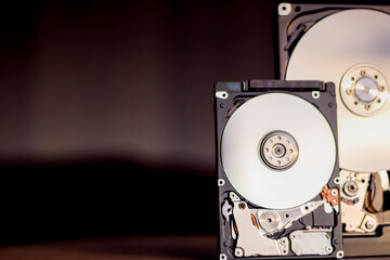 Disassembled hard drive from the computer with mirror effect. Opened hard drive from the computer...