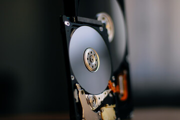 Disassembled hard drive from the computer with mirror effect. Opened hard drive from the computer hard disk drive (HDD)