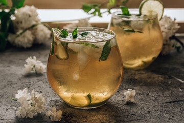 Iced green tea with lime and mint on stone background. Summer refreshing cocktail. Selective focus