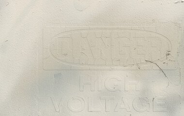 warning or danger sign (high voltage) painted over in off white - text of sign faintly visible 