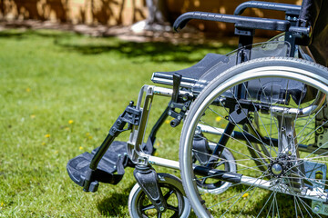 Empty wheelchair in the garden, as the hope of a disabled person who has been cured.