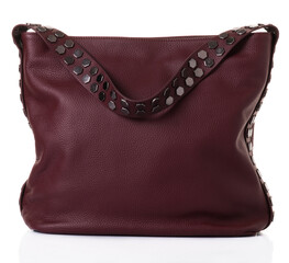 Burgundy bag for women with a wide shoulder strap. The model is made of genuine leather. The belt is decorated with metal rivets in the form of honeycombs. White background