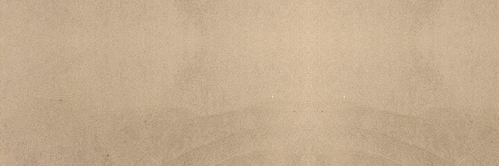 Fototapeta na wymiar Panorama of Light brown fine-grained sand on the beach texture and background seamless