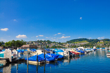 Fototapeta na wymiar Boats parked in harbor in Luzern Lake, Switzerland.