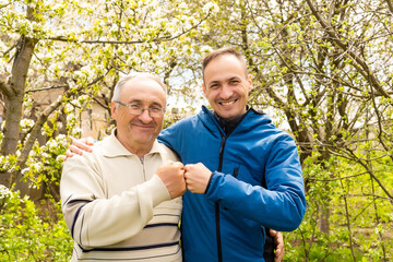Fototapeta premium Father and his son looking at the camera in the garden