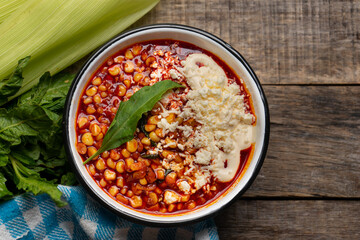 Red corn esquites on wooden background. Mexican food