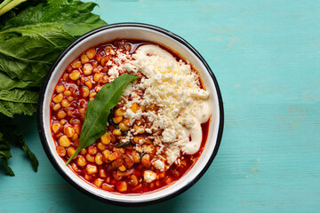 Red corn esquites on turquoise background. Mexican food
