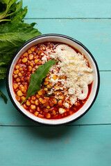 Red corn esquites on turquoise background. Mexican food