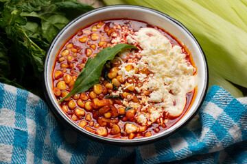 Red corn esquites on wooden background. Mexican food