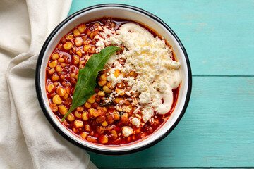 Red corn esquites on turquoise background. Mexican food