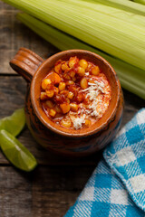 Red corn esquites on wooden background. Mexican food