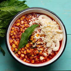 Red corn esquites on turquoise background. Mexican food
