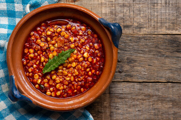 Red corn esquites on wooden background. Mexican food
