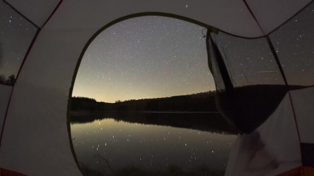 Time lapse through a tent at night with the Milky Way Galaxy rising over Spruce Knob Lake in West Virginia 