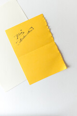 message in French (je t'aime mademoiselle) stamped in black ink on yoke yellow - photographed from above