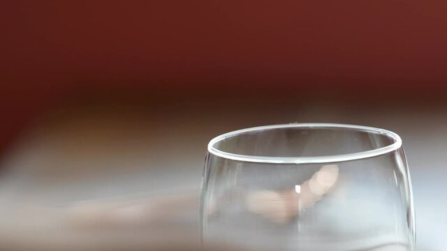 Picking Up Empty Drinking Glasses From A Table Close Up With Hands, Stemless Wine Glasses In A Restaurant For Fine Dining