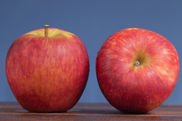 Red ripe apples on blue background