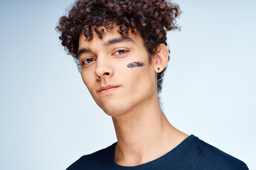 Obraz premium Cheerful man with curly hair cosmetics on face clean skin