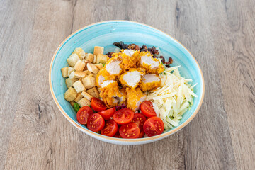Cesar salad with separated ingredients in beautiful sky blue bowl