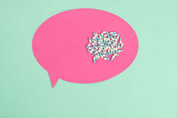 text balloon with medicine capsules symbolizing the conversation about medical treatment