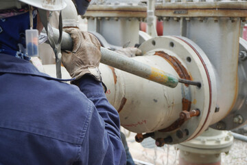 (Focus on the workers hand) Pipeline system during installation by the construction workers in the...
