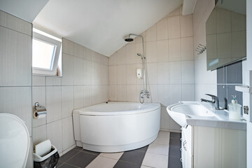 Bathroom bright toilet at home or hotel in day with sink and bath tub