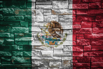 National flag of Mexico on stone  wall background.The concept of national pride and symbol of the...