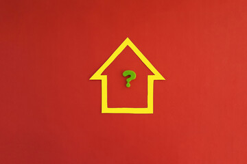 Fototapeta na wymiar The house is yellow, the question mark is green on a red background. Real estate valuation.