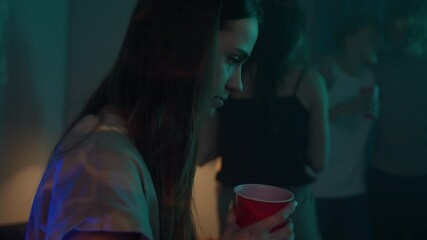Portrait of sad woman, group of students dancing at home, teenagers having party during coronavirus lockdown, dance together in living room. Young friends millenials celebrate birthday holiday.