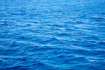 Obraz premium Blue water with sun reflections. Sea background