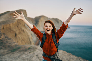  travel with hands up in the mountains near the sea in nature