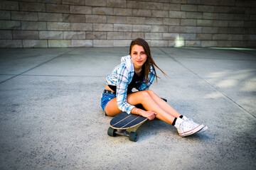 Young Woman Posing with Her Skateboard in an Urban Setting