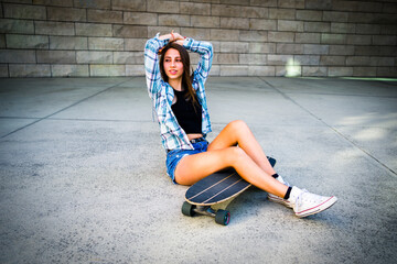 Young Woman Posing with Her Skateboard in an Urban Setting