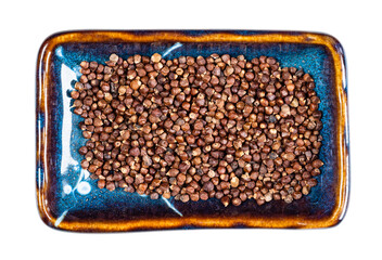 grains of paradise pepper on plate cutout