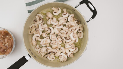 Raw chopped mushrooms on a frying pan close up view from above