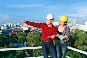 Asian contractors looking away and making notes