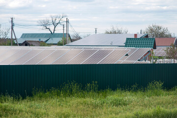 Solar panels in a private area near the house behind the fence