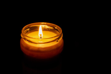 burning candle in the dark