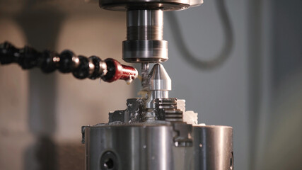 Produces metal detail in factory. Machine tools for metal working. A metal workpiece is machined by an electric machine. Cutting metal modern processing technology. Coolant and lubrication.