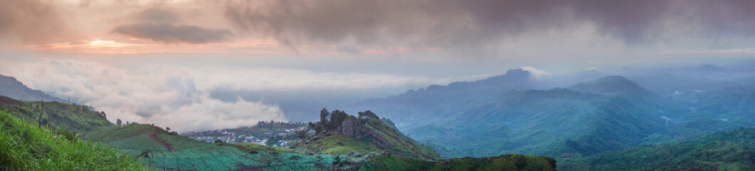 Mountain peak panorama view in the morning It is covered with sunshine and clouds.