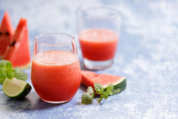 watermelon smoothie drinks on blue marble background.