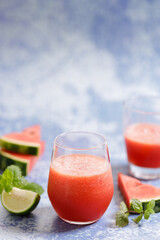 watermelon smoothie drinks on blue marble background.