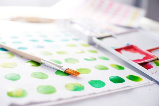 Watercolor paints and brushes workplace artist with artistic tools for mock up.