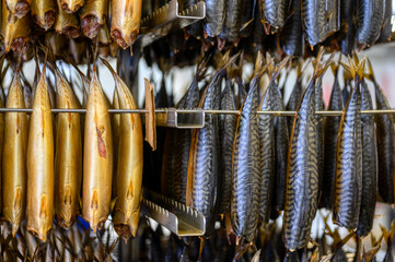 Industrial smoking of fish. Mackerel is suspended from a smoking oven.