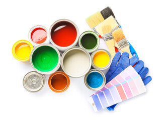 Cans of paints and tools on white background
