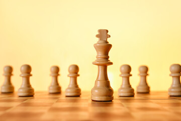 Chess pieces and game board on color background