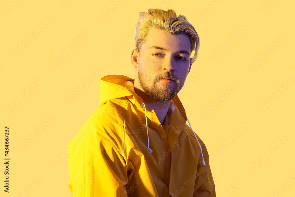 Poster Toned portrait of handsome young man on color background