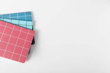 Checkered notebooks on white background