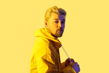 Toned portrait of handsome young man on color background